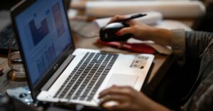 Computer engineer working on hardware and software integration at workstation.